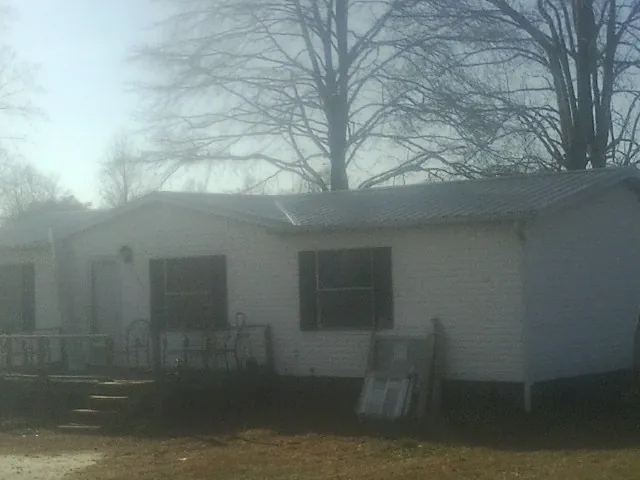 New metal roof on a white painted brick home on a foggy morning in Pleasant Hill